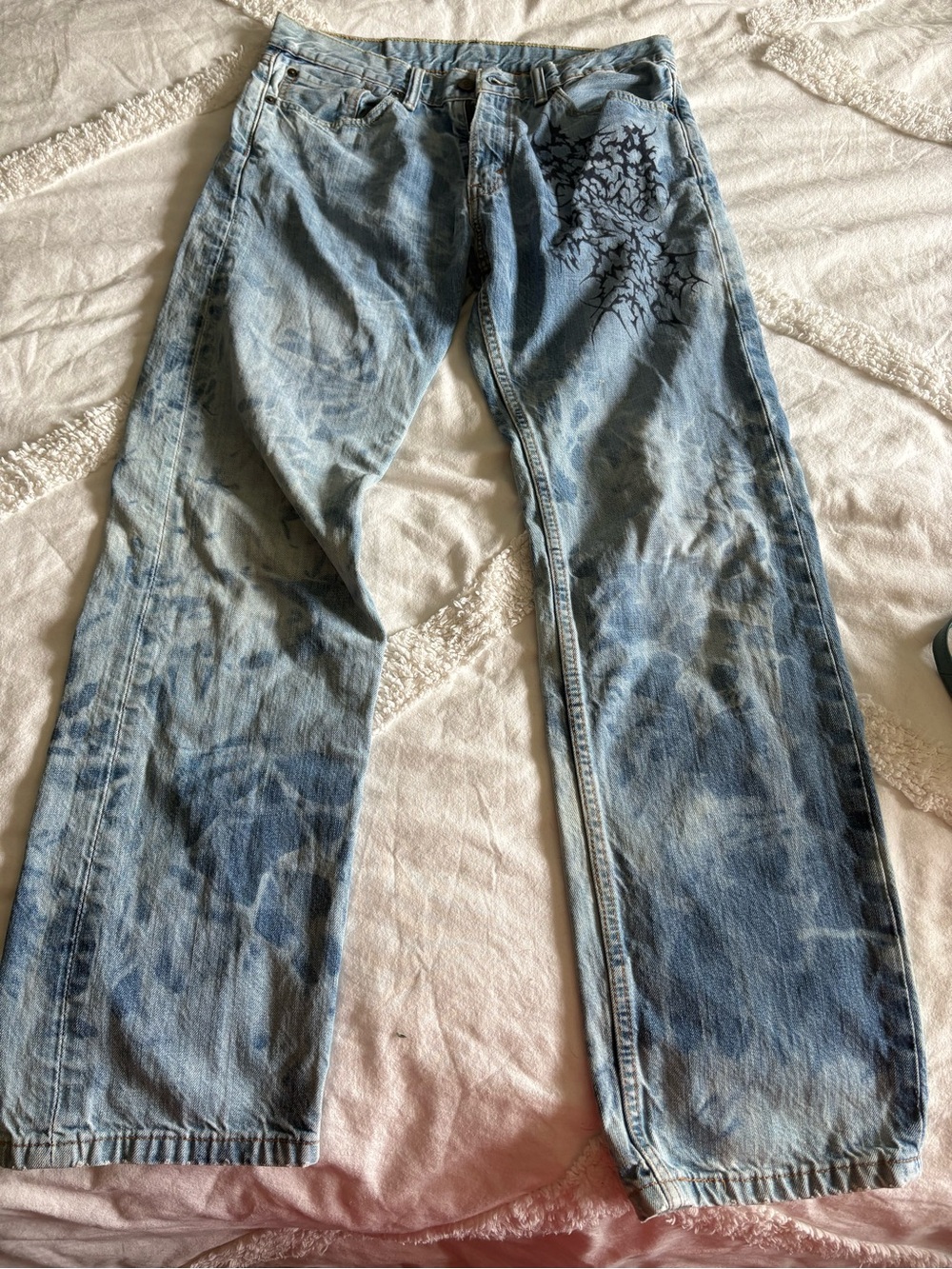 Levi's light blue denim jeans with brown leather patch and red print